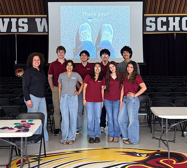 EECU staff and Clovis West Student workers standing in front of screen